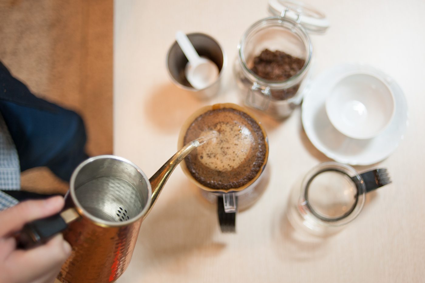 Hot water being poured onto a bed of ground coffee in a filter